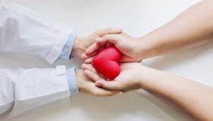 doctor patient holding red heart together scaled