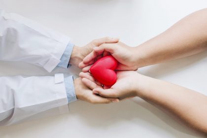 doctor patient holding red heart together scaled