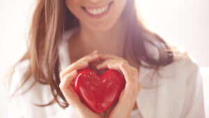 red heart in the hands of a woman scaled red heart in the hands of a woman scaled